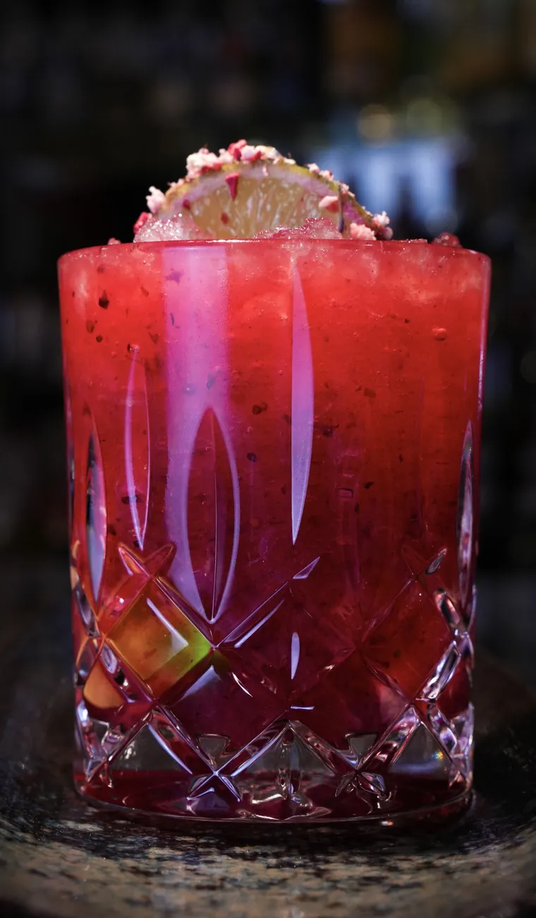 Red cocktail in a crystal glass